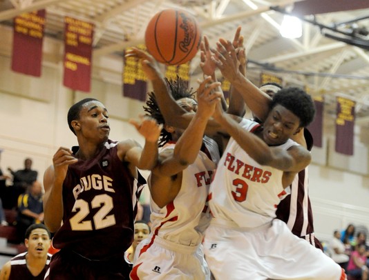 Willow Run's Kareem Lovelance Jr. (10), center left, and McKenzie Dunlap (3), center right, fight for a rebound against River Rouge's Robert Metcalf, left, and Devonte Johnson, far right. Angela J. Cesere | AnnArbor.com